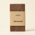 Barnwood soap with its paper label on a warm ivory background
