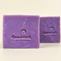 Two purple Lavender Rose soap bars stamped with Gooseneck Soap Company branding on a warm ivory background