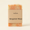 Bergamot Wave soap with its paper label on a warm ivory background