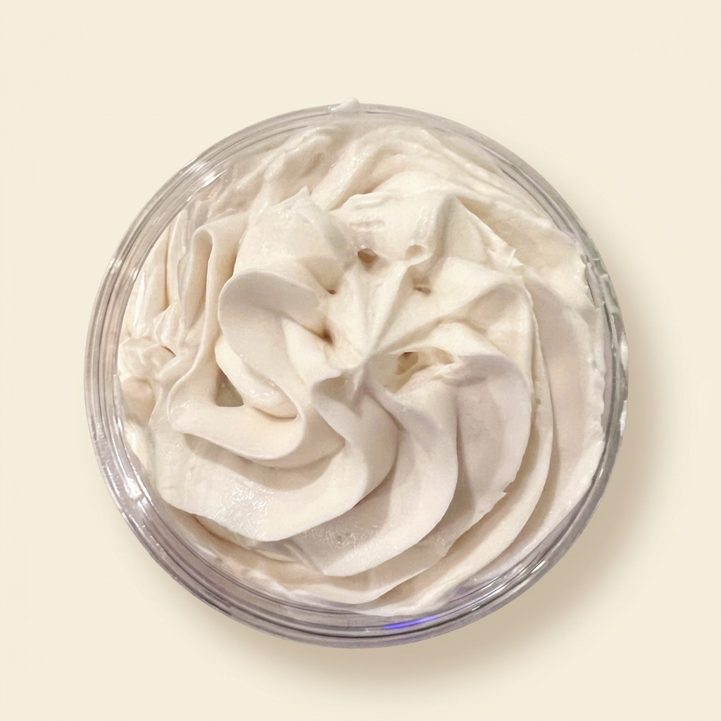 Open jar of Triple Butter Whipped Body Butter on a warm ivory background